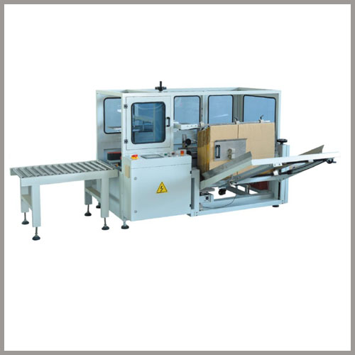 Machine verticale automatique de déballage et de scellage de fond de caisses